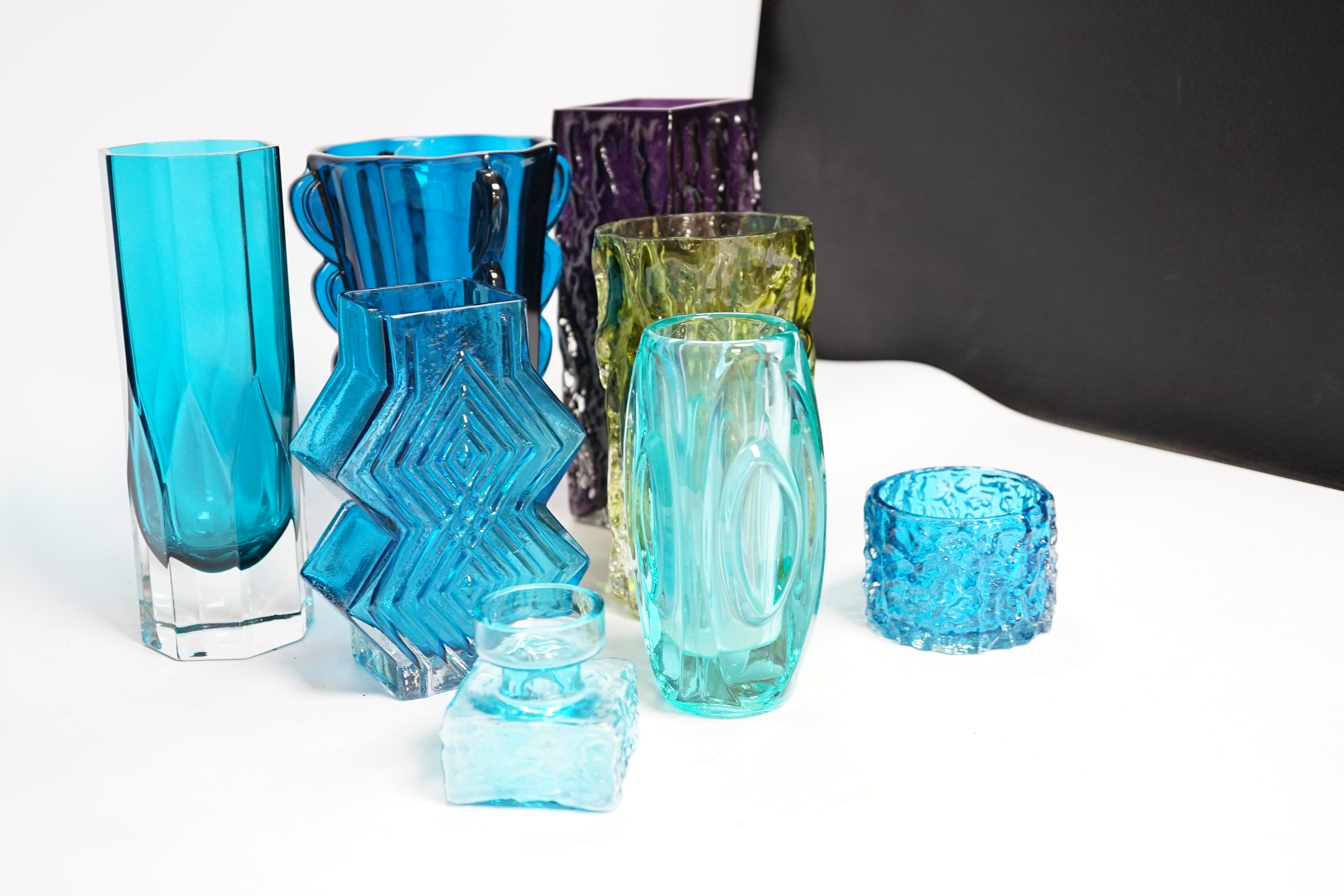 Eight coloured glass vases, including Whitefriars mobile phone vase in kingfisher blue, 22cm high